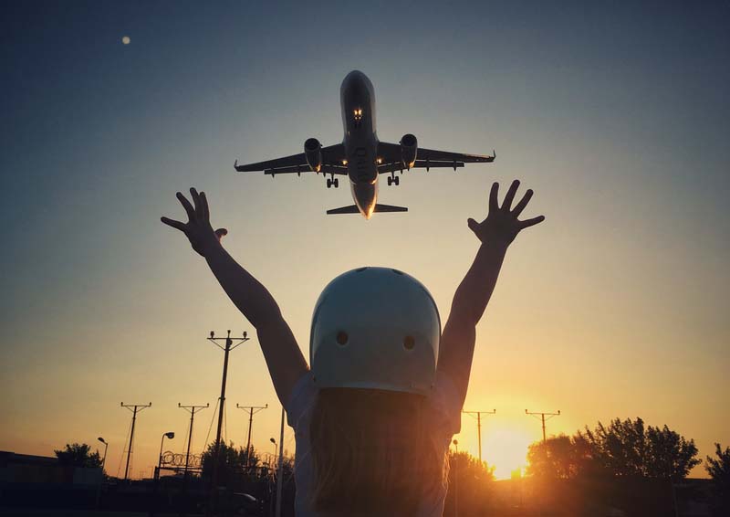 Small girl pointing to airplane
