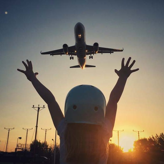 Small girl pointing to airplane